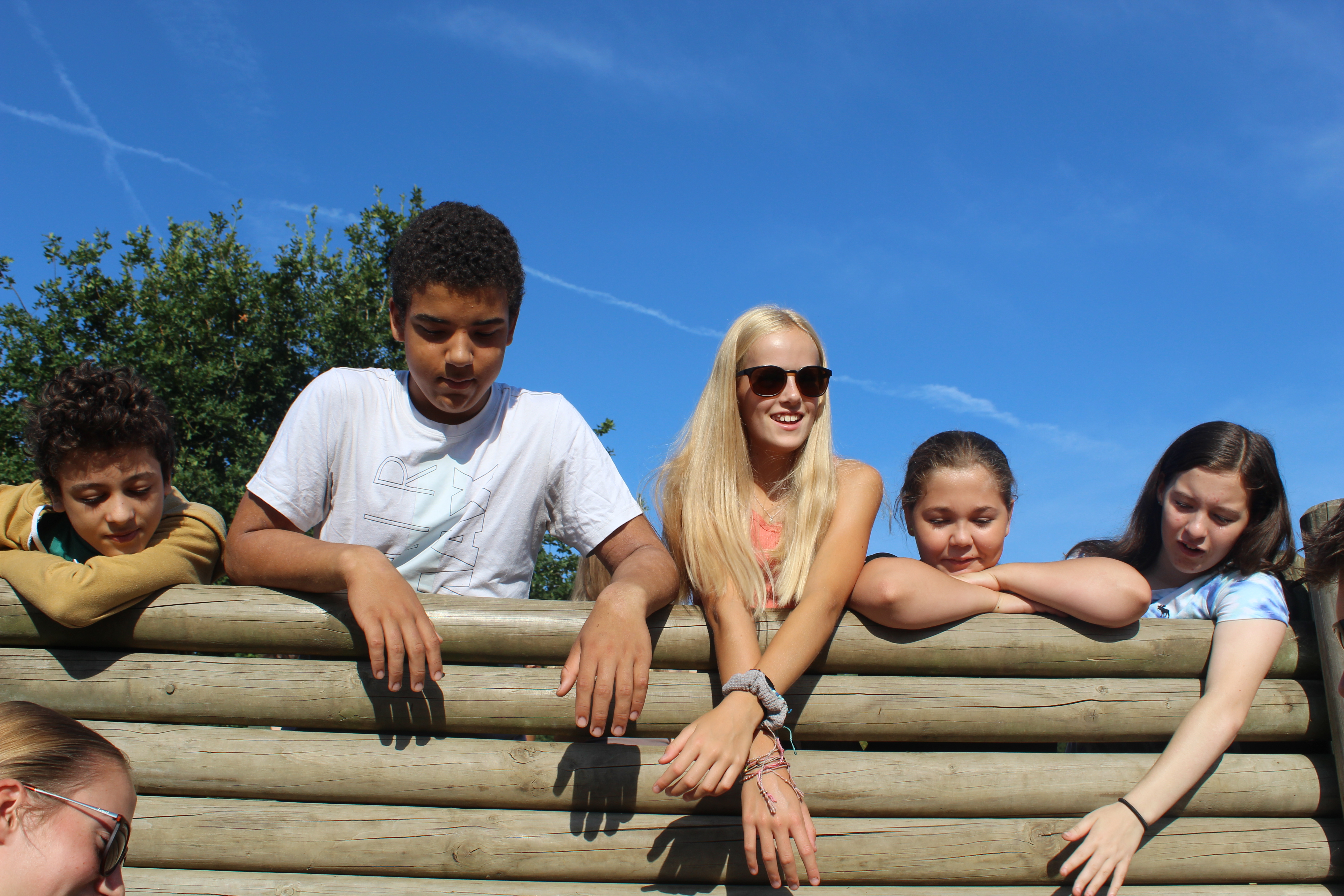 5 children smile on a climbing wall during a residential trip 