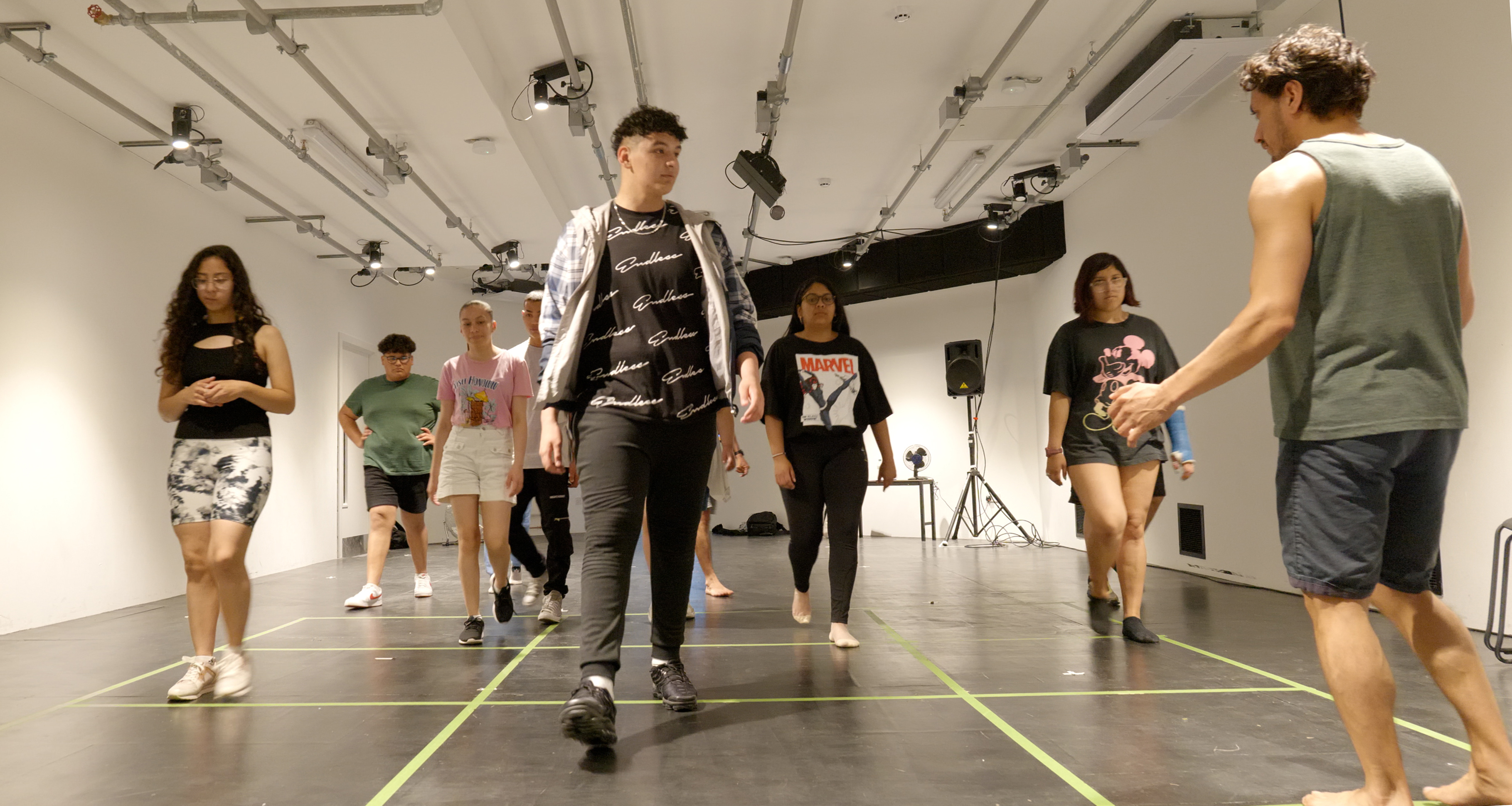 Young people walking in lines in a rehearsal room