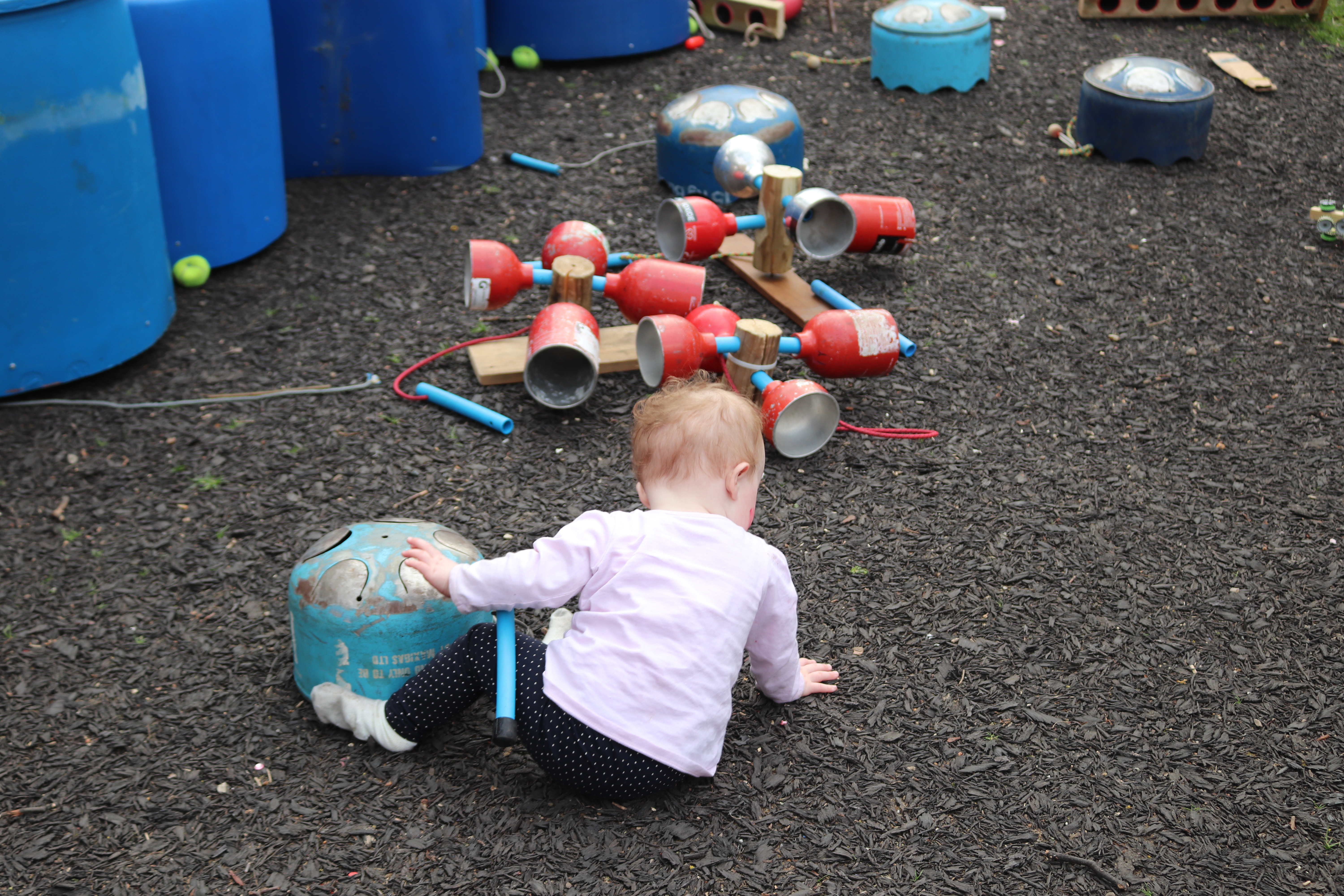 Baby playing with junk orchestra