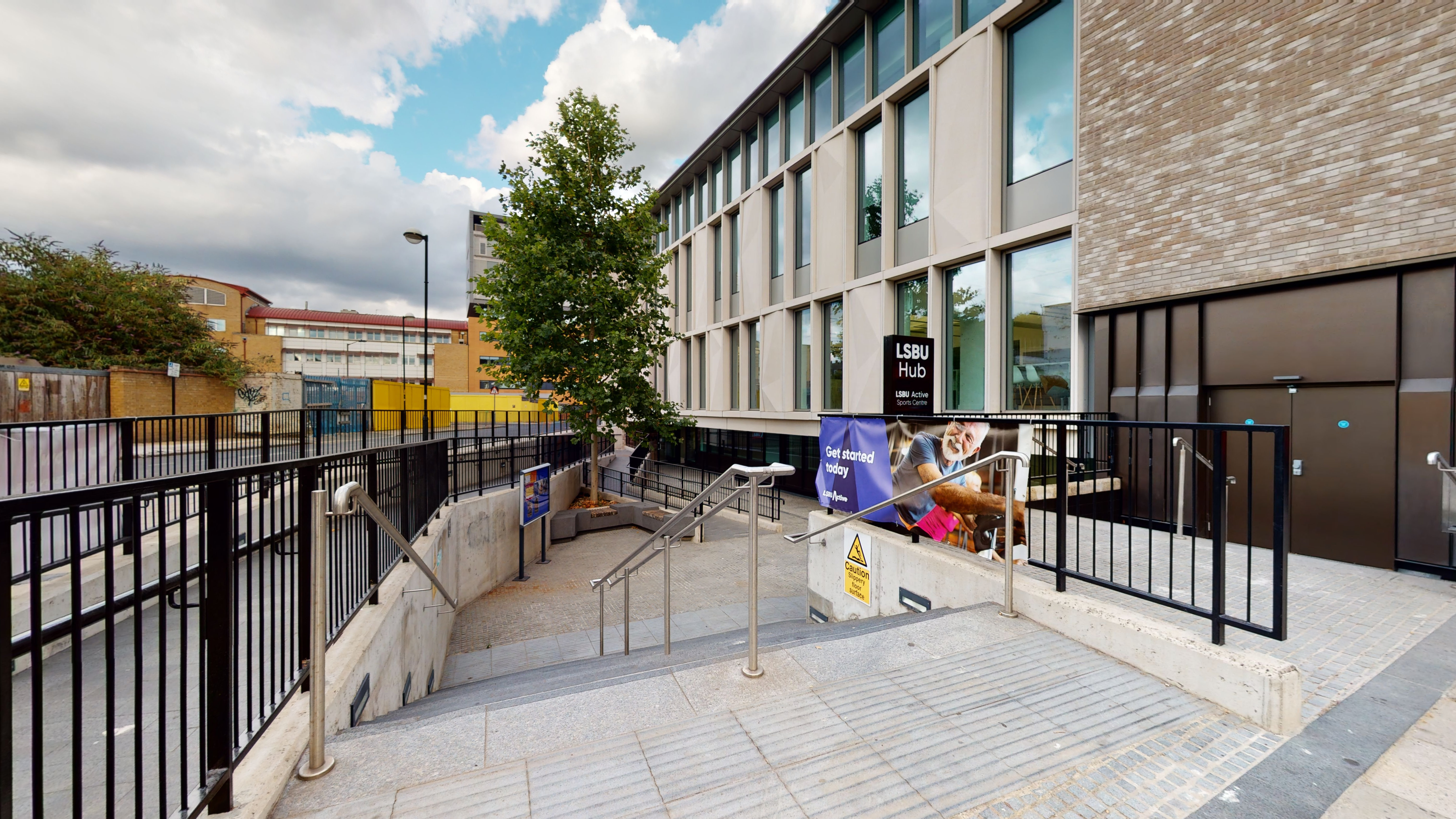 Black railings and steps and ramp down to entrance of LSBU Active